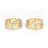 A pair of 18 karat gold diamond meander rings