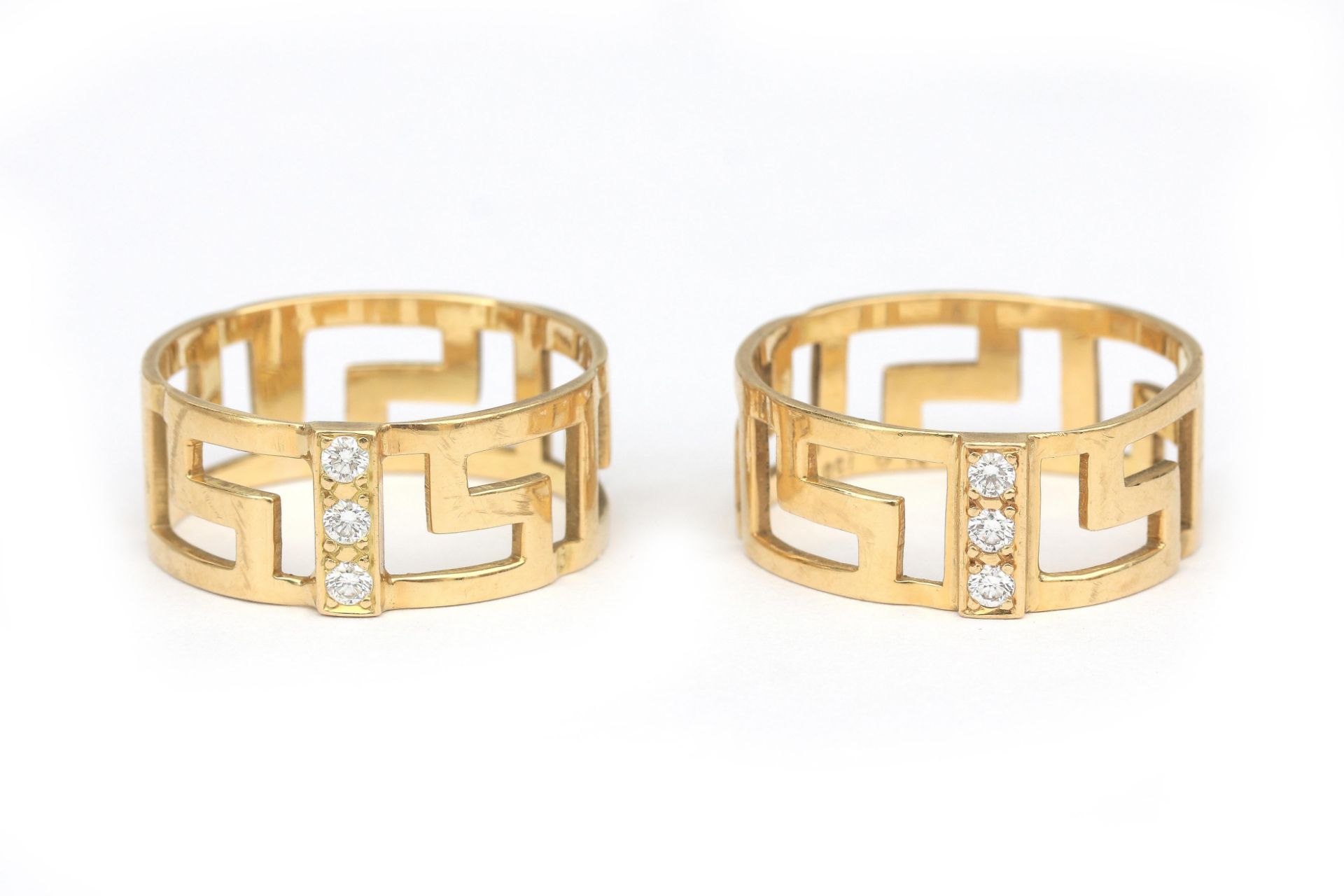 A pair of 18 karat gold diamond meander rings