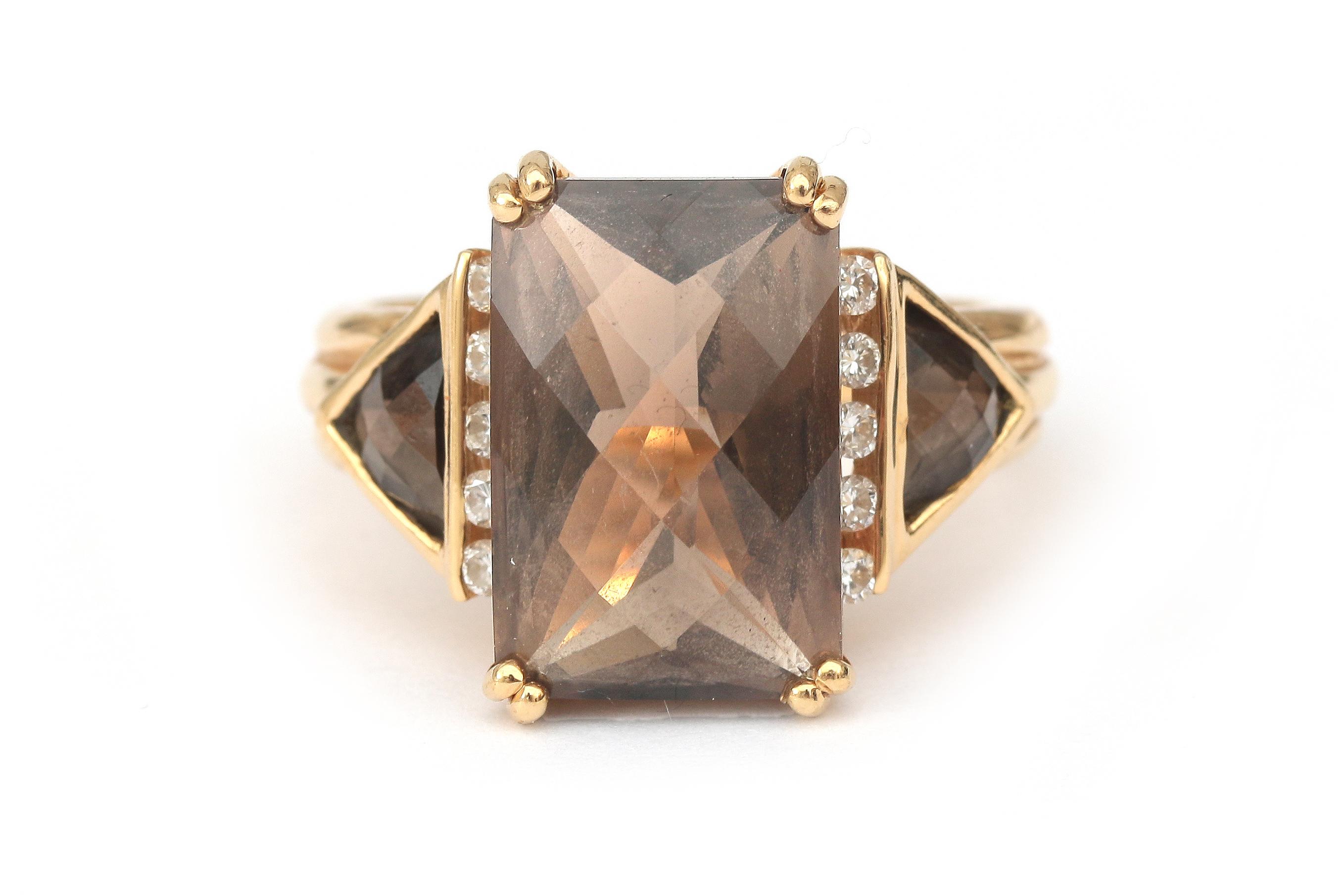 An 18 karat gold smokey quartz and diamond ring