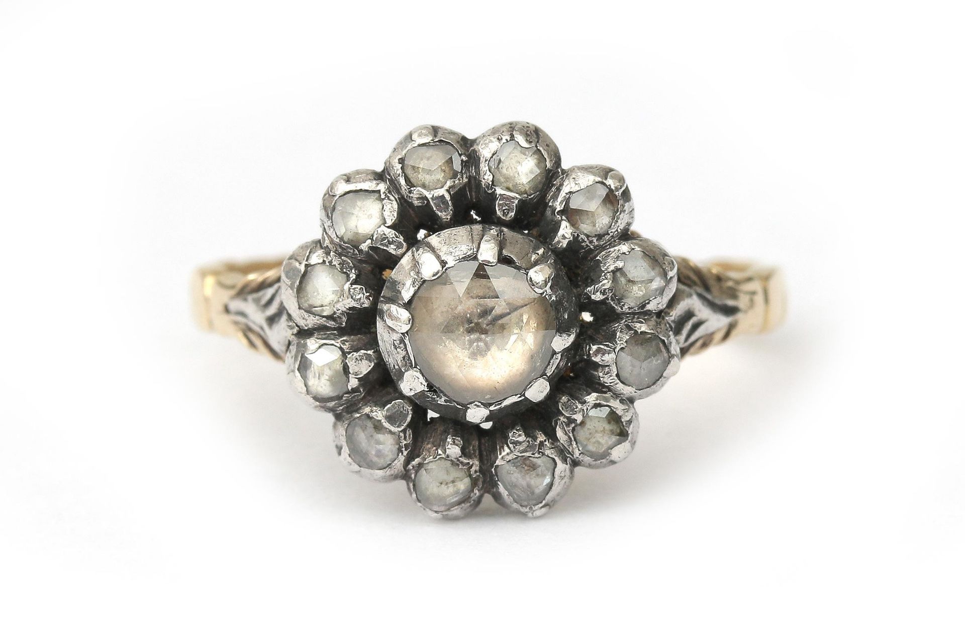 A 14 karat gold with silver rose cut diamond cluster ring