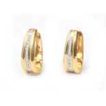 A pair of 18 karat gold diamond ear hoops
