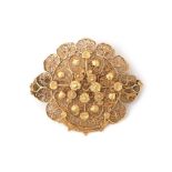 A 14 karat gold filigree brooch
