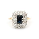 An 18 carat gold two tone cluster ring with sapphire and diamonds
