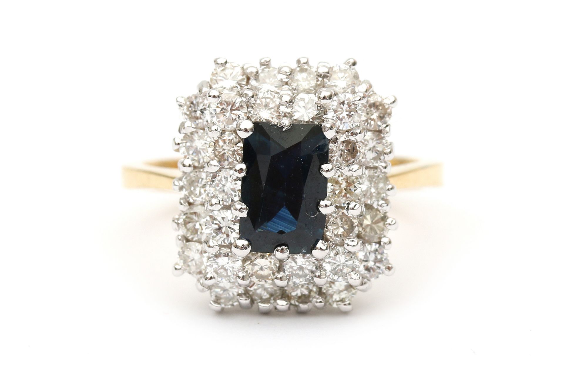 An 18 carat gold two tone cluster ring with sapphire and diamonds