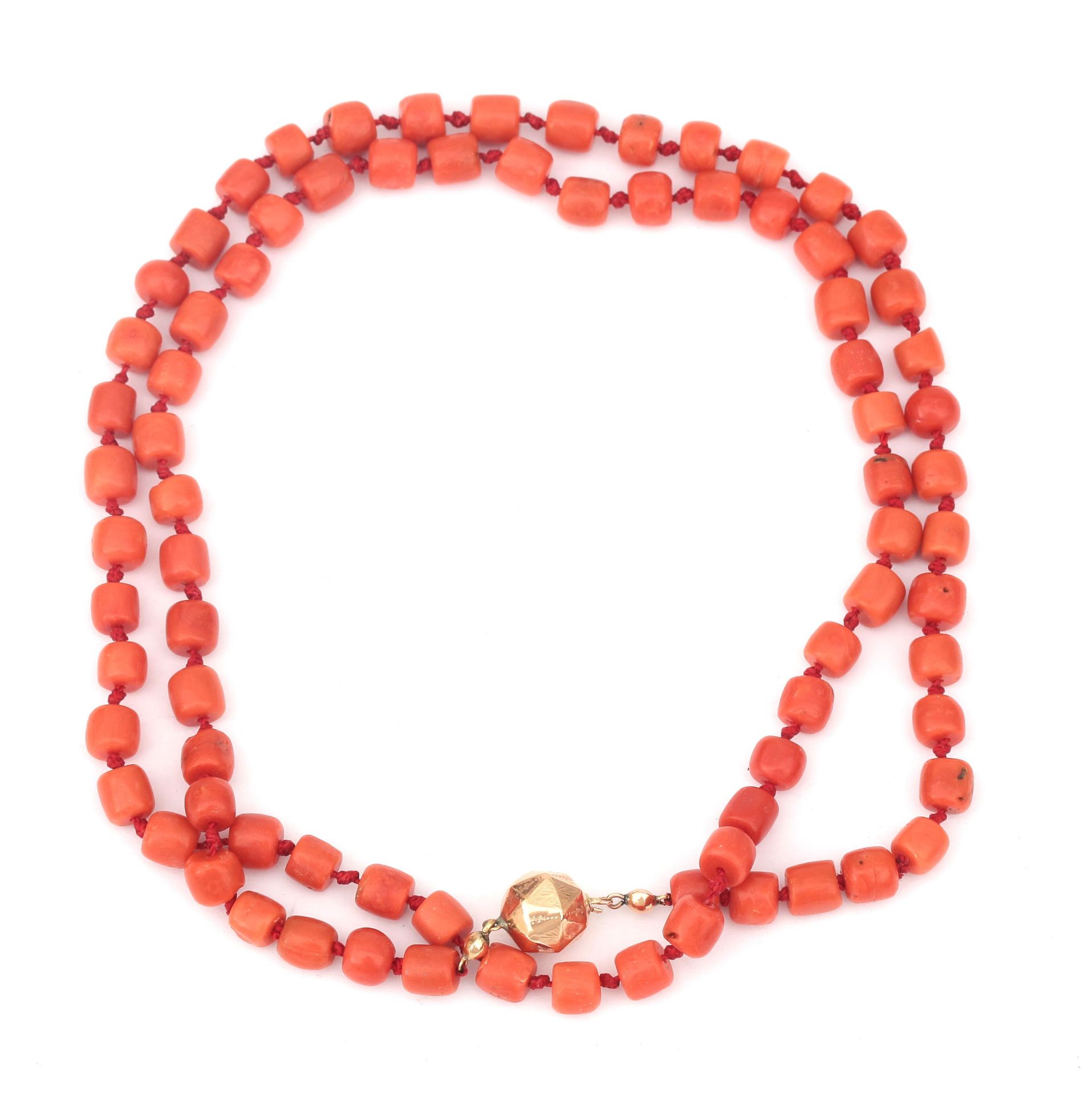 A precious coral bead necklace to a 14 karat gold clasp