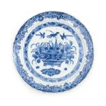 A Delft blue dish with flower basket motif.