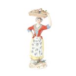 A Meissen figurine of a female fruit merchant.