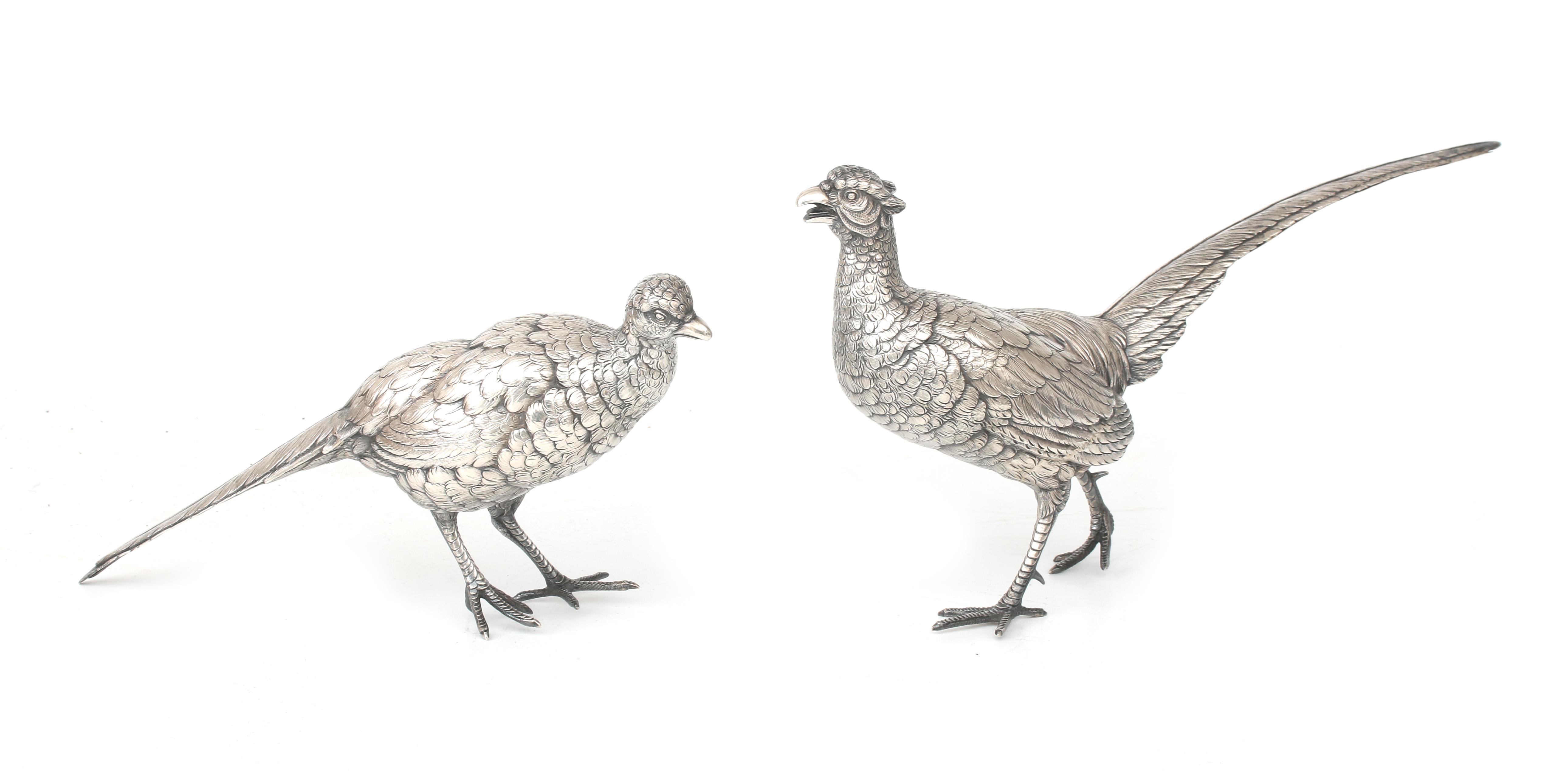 Two silver center pieces: pheasants.