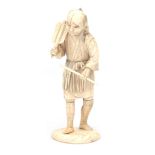 An carved ivory okimono of a man with a basket, circa 1900.