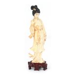 A carved ivory okimono of a young woman.