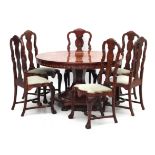 An inlaid extending dining table with six chairs.