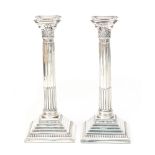 A pair of column shaped silver candle sticks.