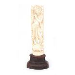 An carved ivory sculpture of Krishna, playing a flute.