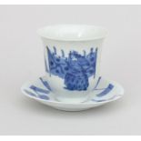 A Japanese porcelain cacao cup and saucer.