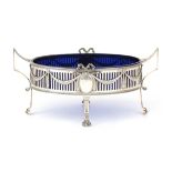 A pierced silver jardinière with cobalt blue glass liner.