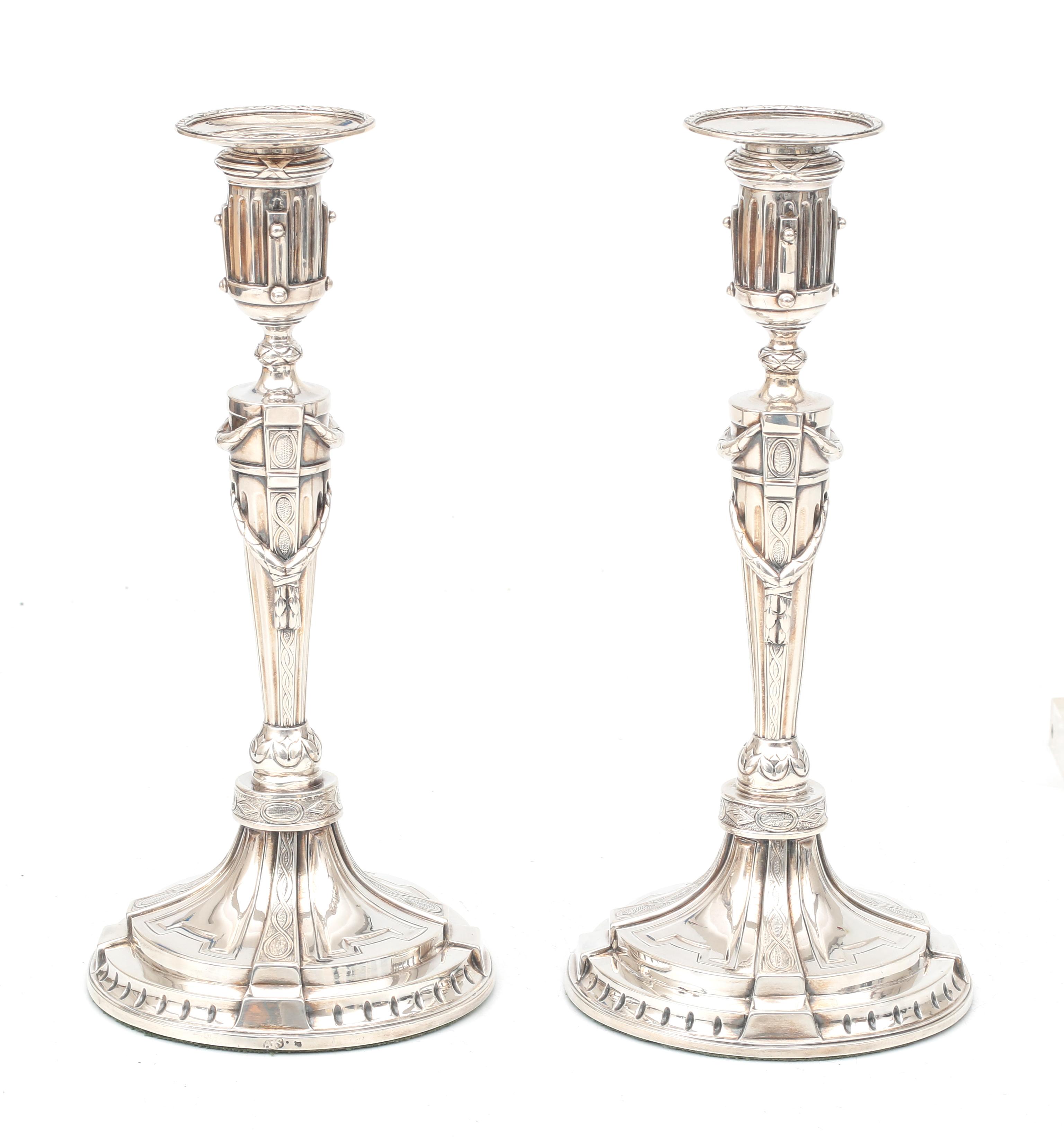 A pair of Louis Seize silver candle sticks.