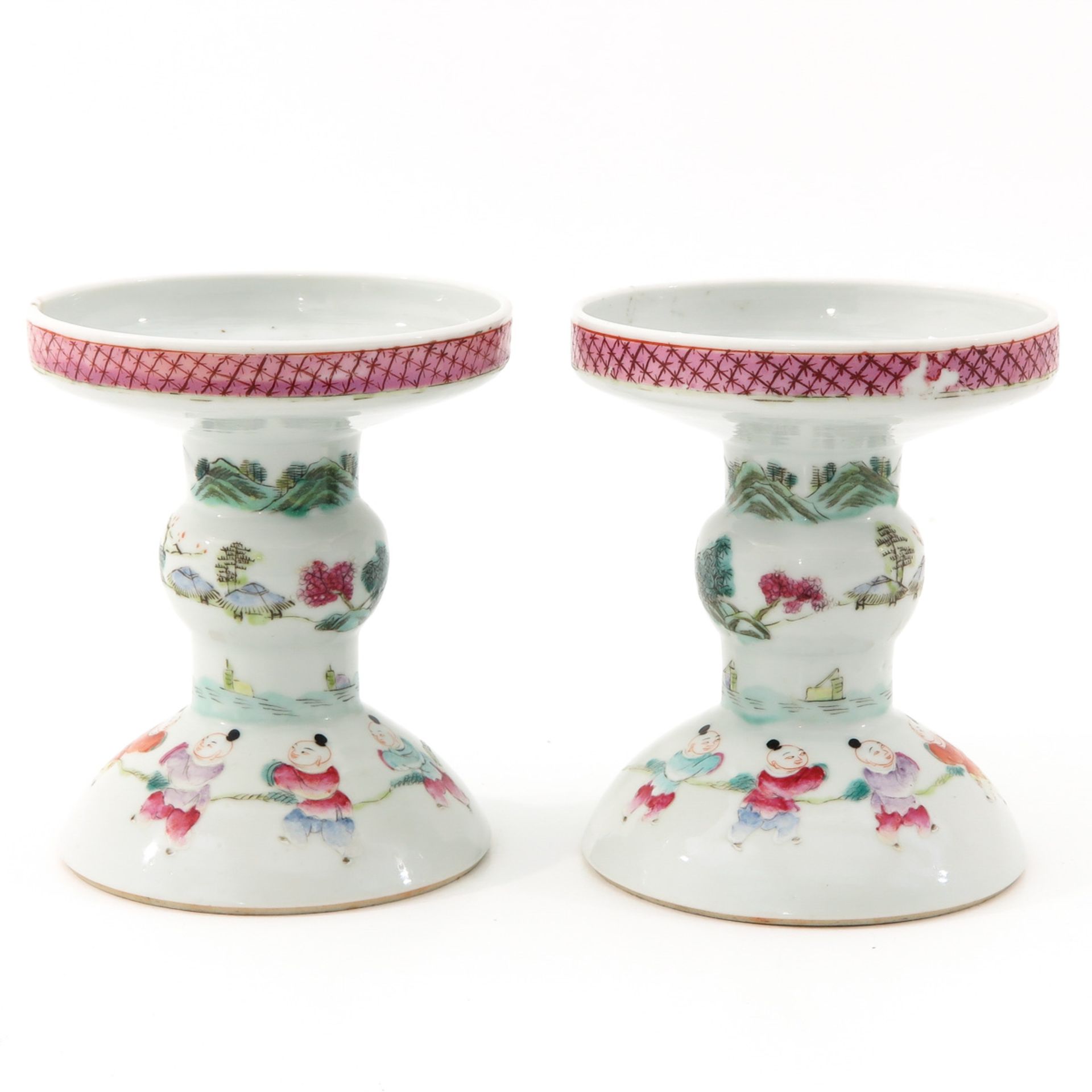 A Pair of Famille Rose Candlesticks