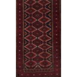 A Baluchi rug, IranWool and cotton of geometric pattern in bordeaux, blue and beige shades<b