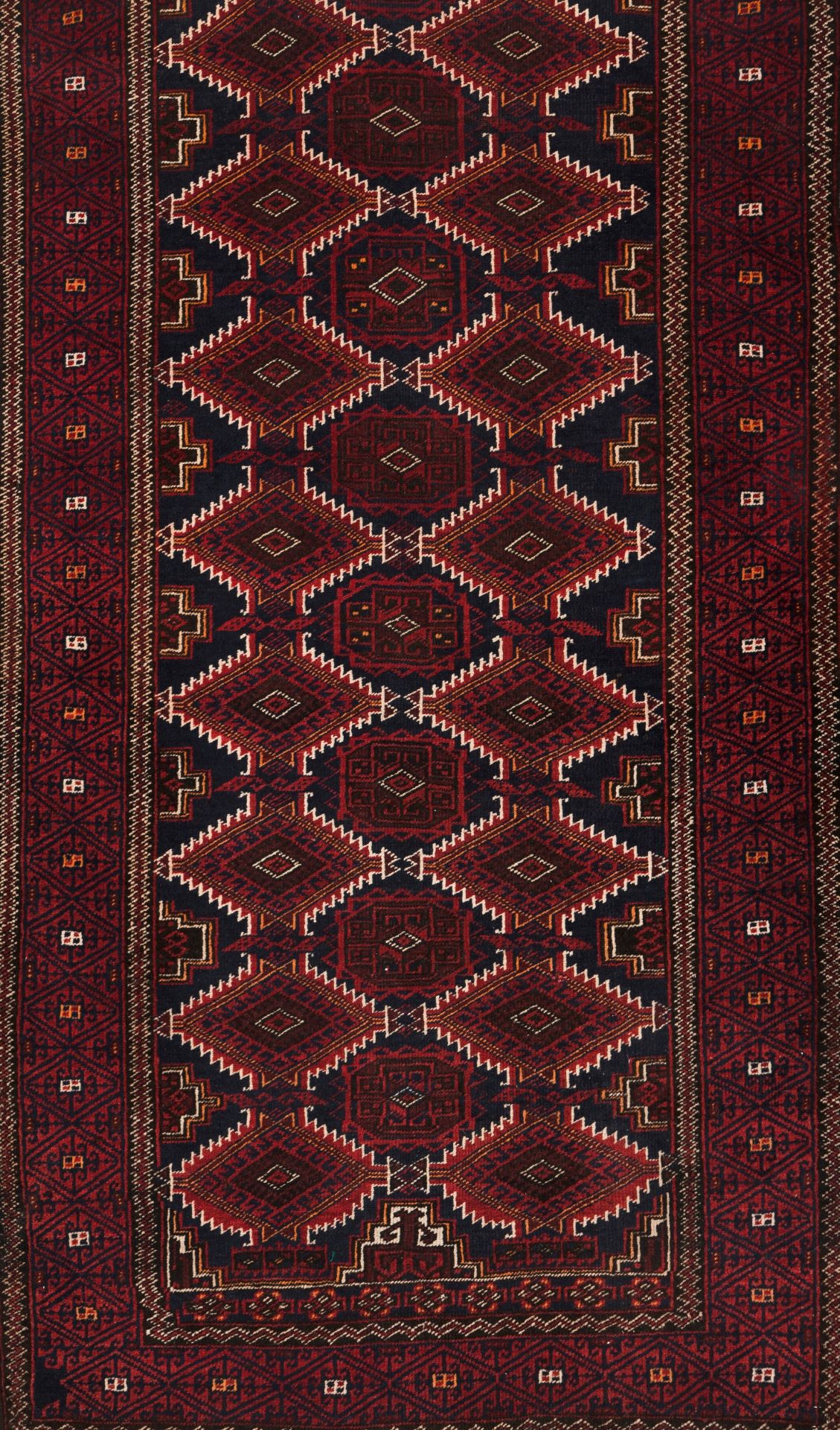 A Baluchi rug, IranWool and cotton of geometric pattern in bordeaux, blue and beige shades<b