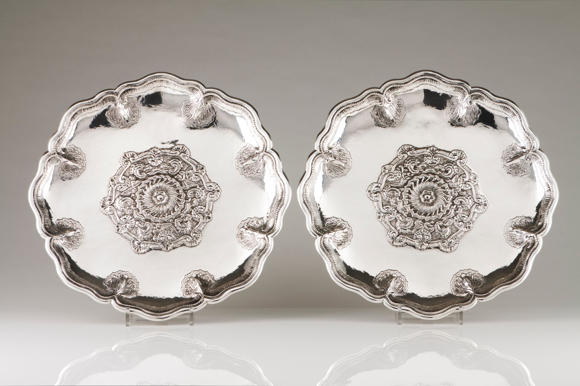 A pair of suspending salversSilver Raised central rose decoration, scalloped and grooved lip eng