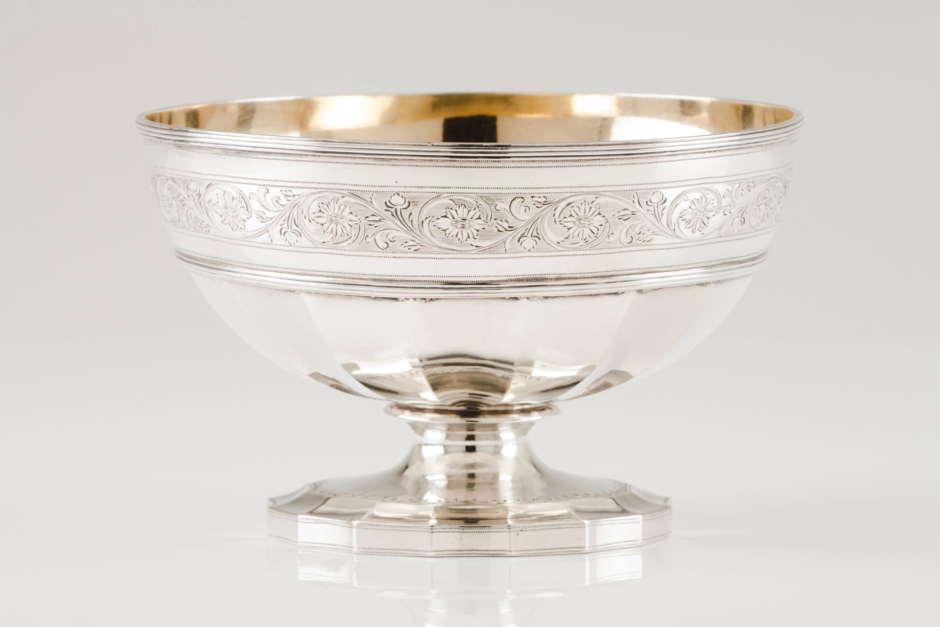 A footed bowlEnglish silver Part faceted body of engraved floral and foliage band on a scalloped