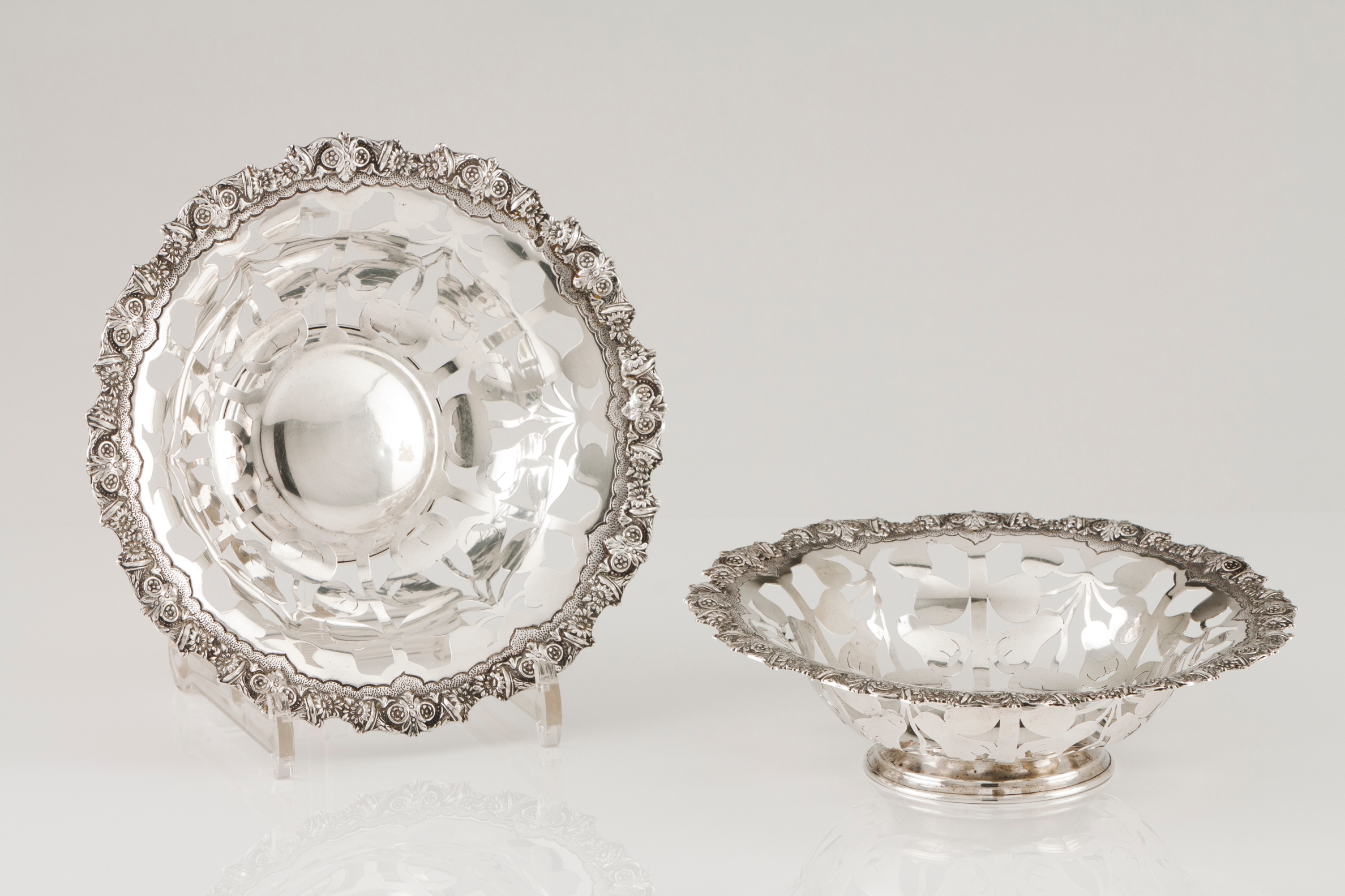 A pair of basketsPortuguese silver Fruits pierced decoration and scalloped lip of raised foliag
