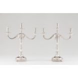 A pair of three branch candelabraPortuguese silver Turned shaft of engraved friezes Grooved and
