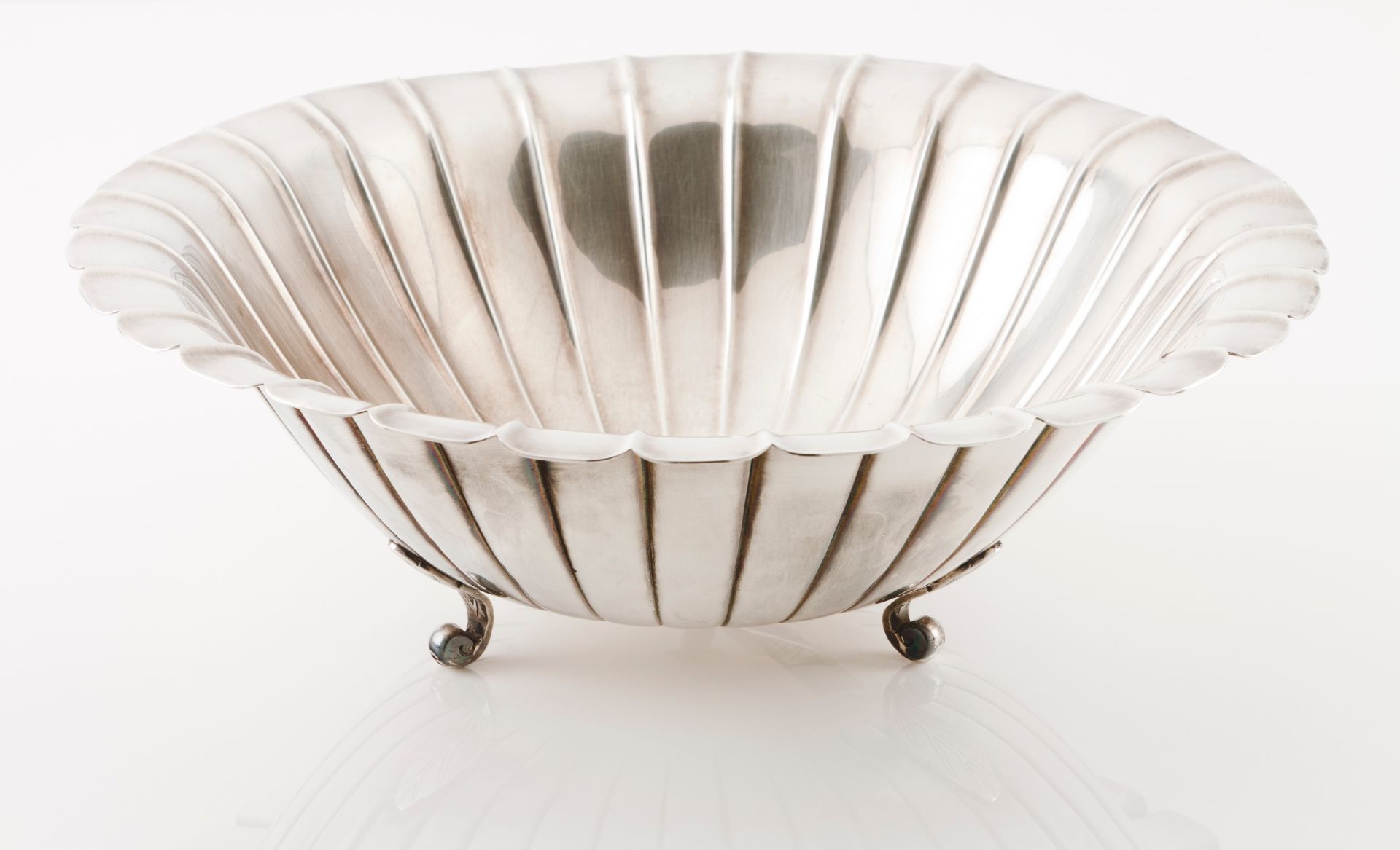 A large fruit bowlChinese silver Circular shaped of grooved fluting, on 3 scrolled leaf feet Ea