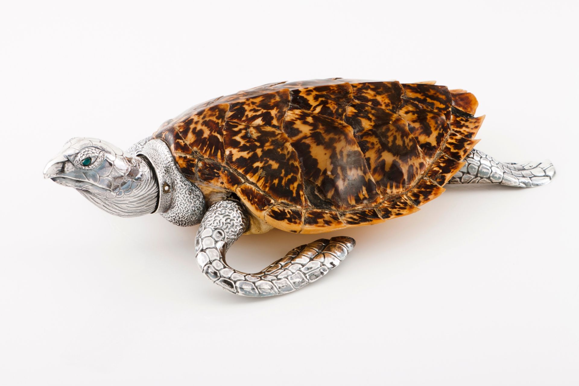 A tortoise Moulded and engraved silver mounded on taxidermized tortoise with green agate eyes Ea