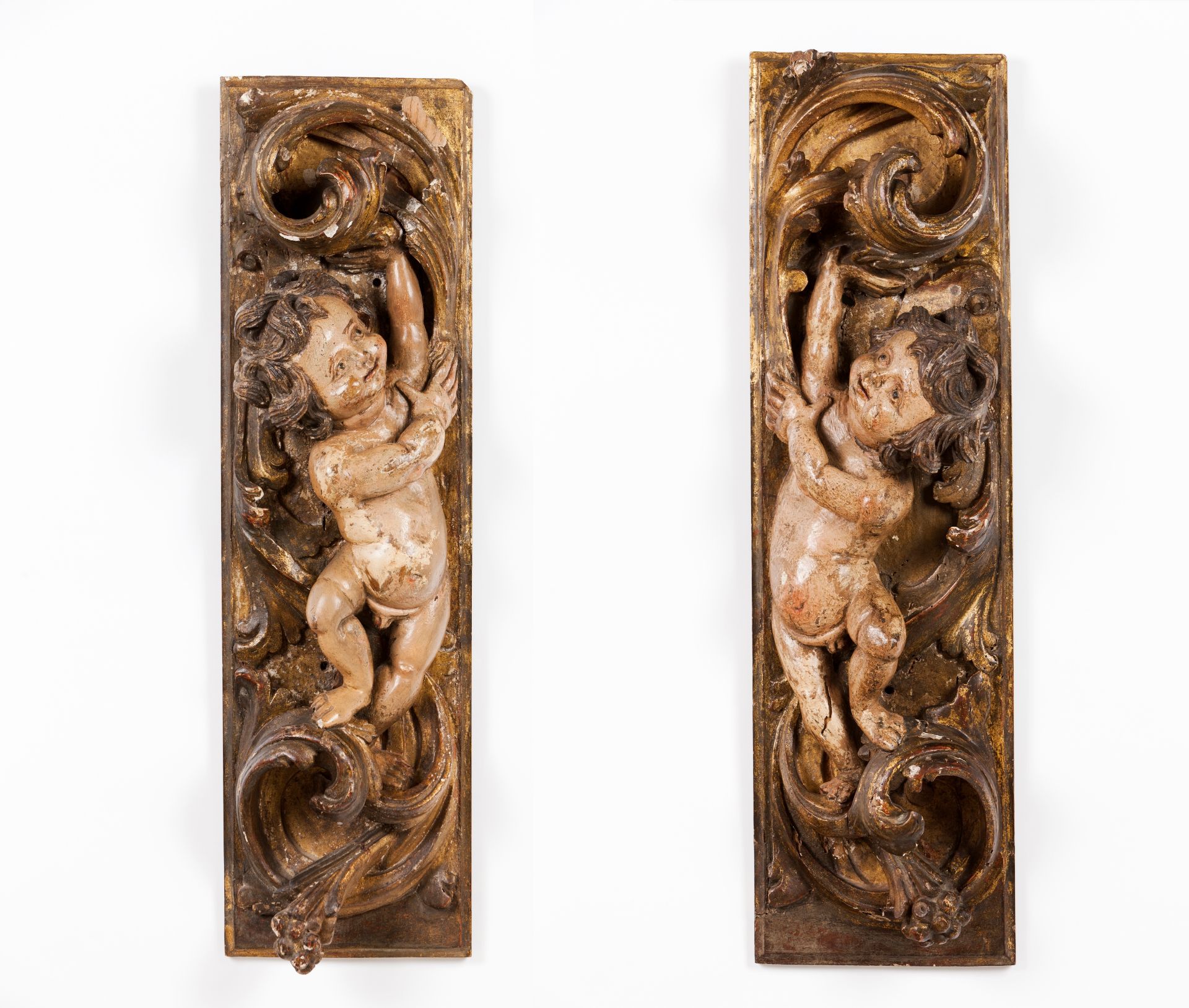 A pair of carved fragments with cherubs