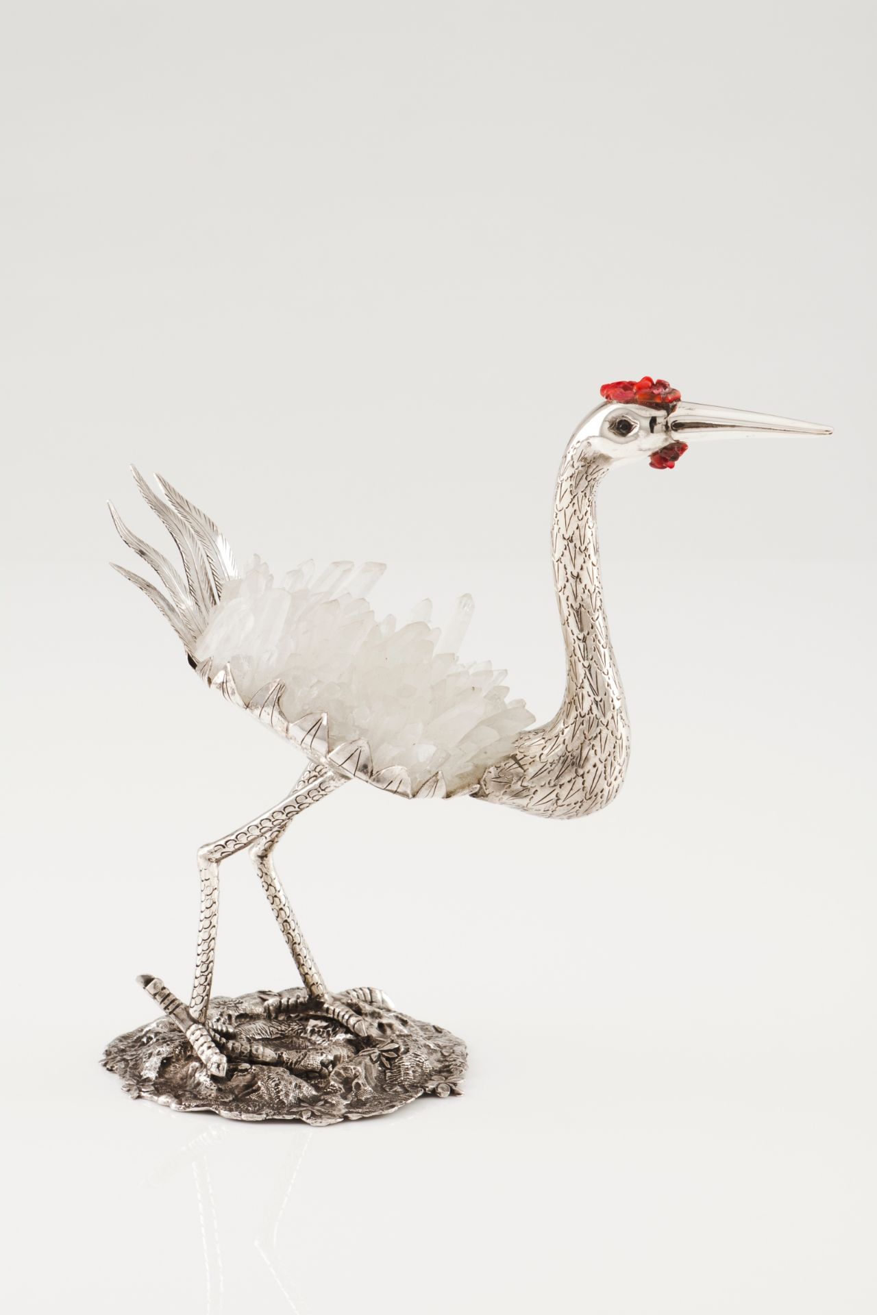 A long legged birdSilver and quartz crystal Moulded, scalloped and engraved decoration withe app