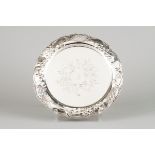 A salverPortuguese silver Central chiselled floral decoration with part pierced lip of raised fl