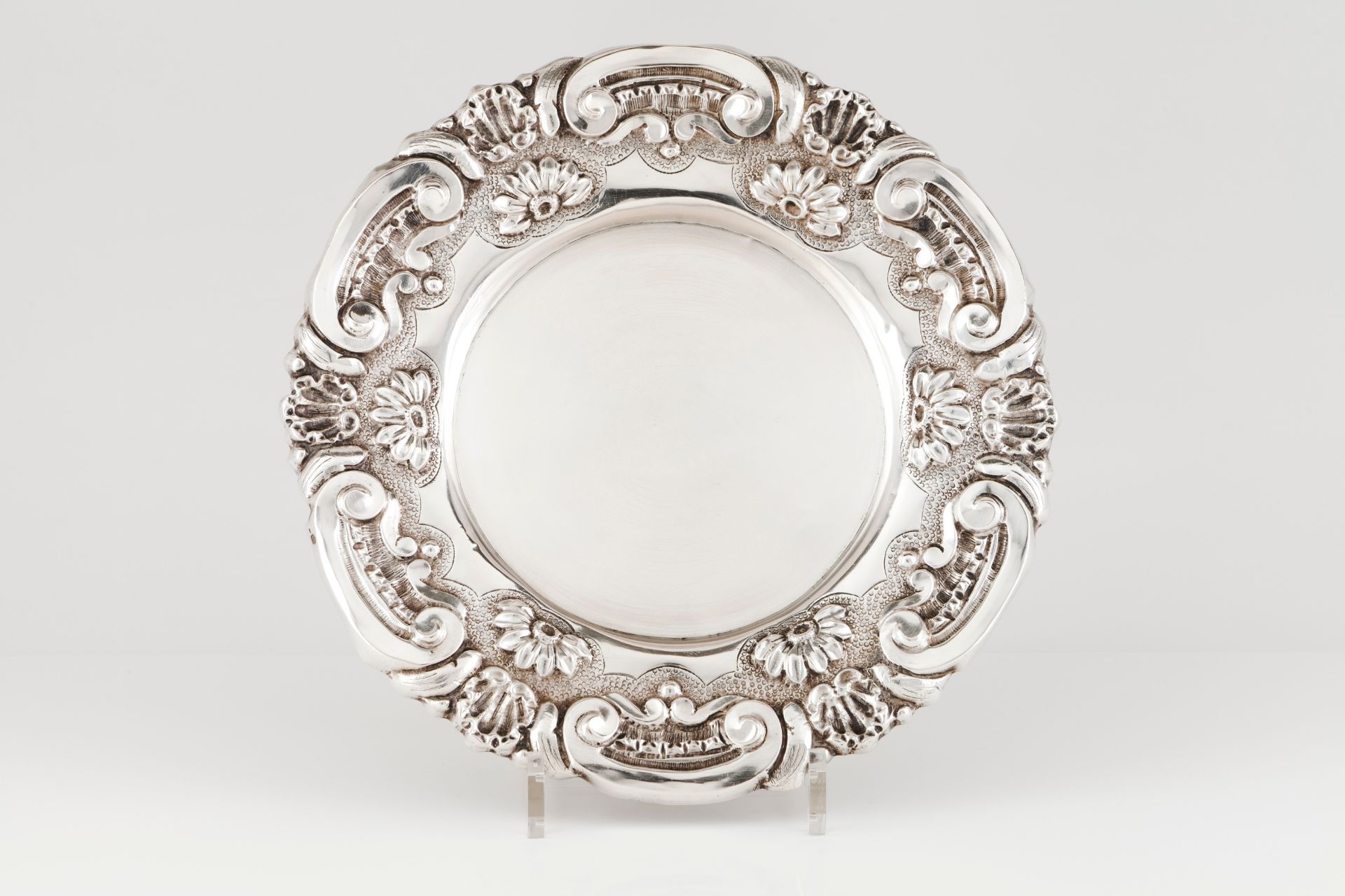 A salverPortuguese silver Plain centre of raised winglet, shell and floral decoration to lip Eag