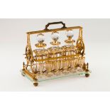 A Baccarat tantalusGilt bronze stand with glass base and bottle lock Three bottles and 12 gilt d