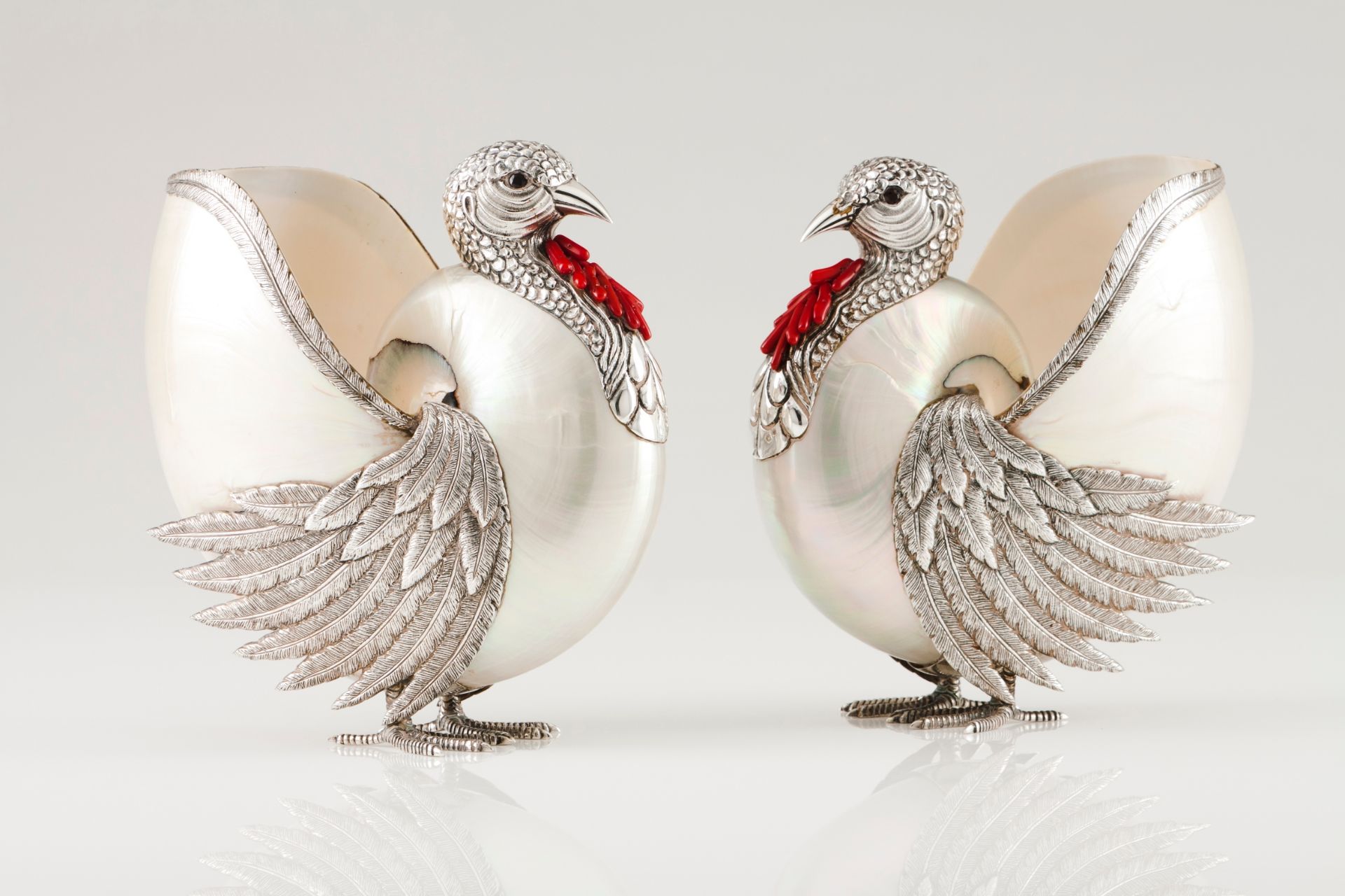 A pair of turkeysPortuguese silver and nautilus shell Moulded, chiselled and engraved silver wit