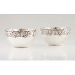 A pair of bowlsPortuguese silver Plain body of raised wide band with medallions and floral and f