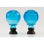 A pair of pine conesBlue cut glass Metal fittings