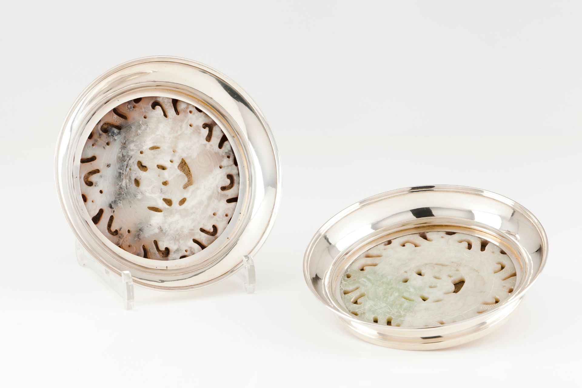 A pair of Luiz Ferreira coastersPortuguese silver Circular shaped with carved jadeite applied el