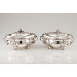 A pair of tureens and coversSilvered metal Baroque decoration, undulating elliptic body of rais