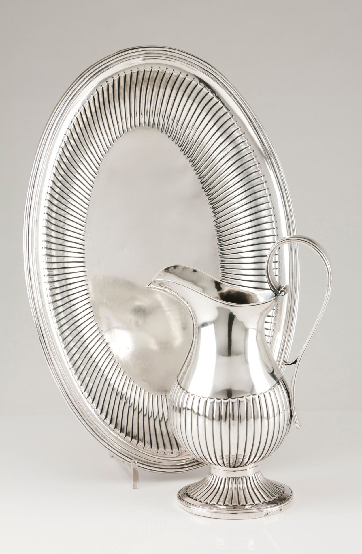 A ewer and basinPortuguese silver, 19th century Part fluted body, scalloped spout and scrolled v