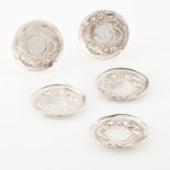 A set of five small platesChinese silver Raised decoration of oriental motifs Later marked Rabbi