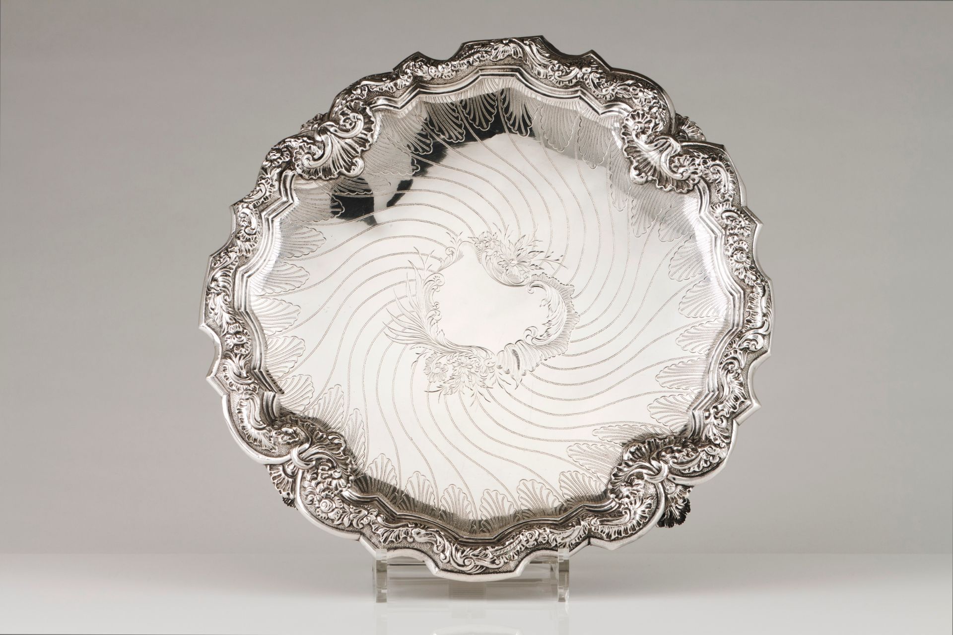 A salverPortuguese silver Engraved centre of foliage framed cartouche of spiralled lines Scallo