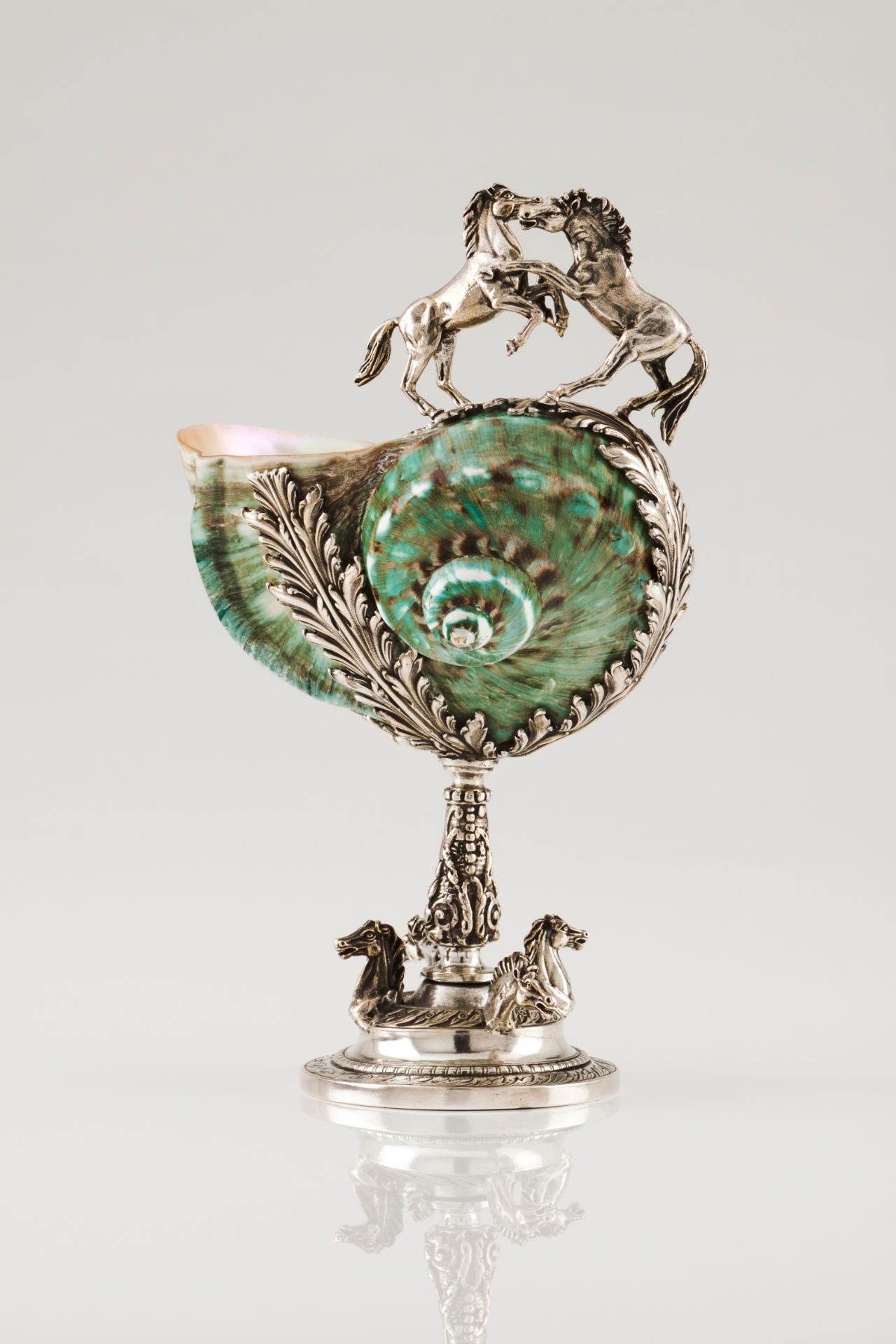 A footed bowlSilver and nautilus Moulded bowl of foliage and equestrian decoration Rabbit hallma