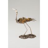 A long legged birdSilver and stone composite Moulded, scalloped and engraved sculpture on a natu
