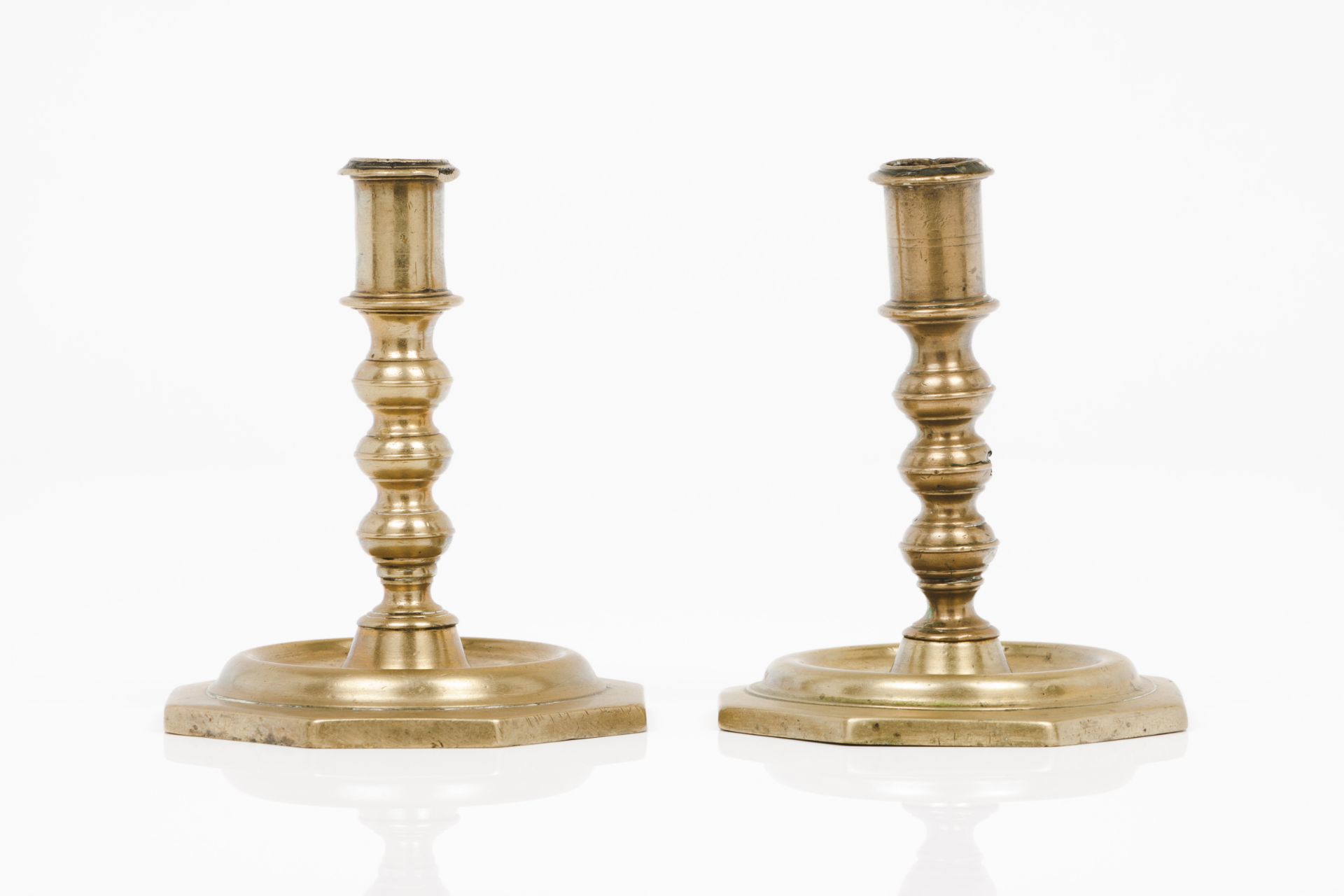 A pair of candle standsTurned bronze Octagonal stands Portugal, 17th century (signs of wear)