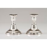 A pair of small candle standsPortuguese silver Plain turned loaded body Eagle hallmark 925/1000