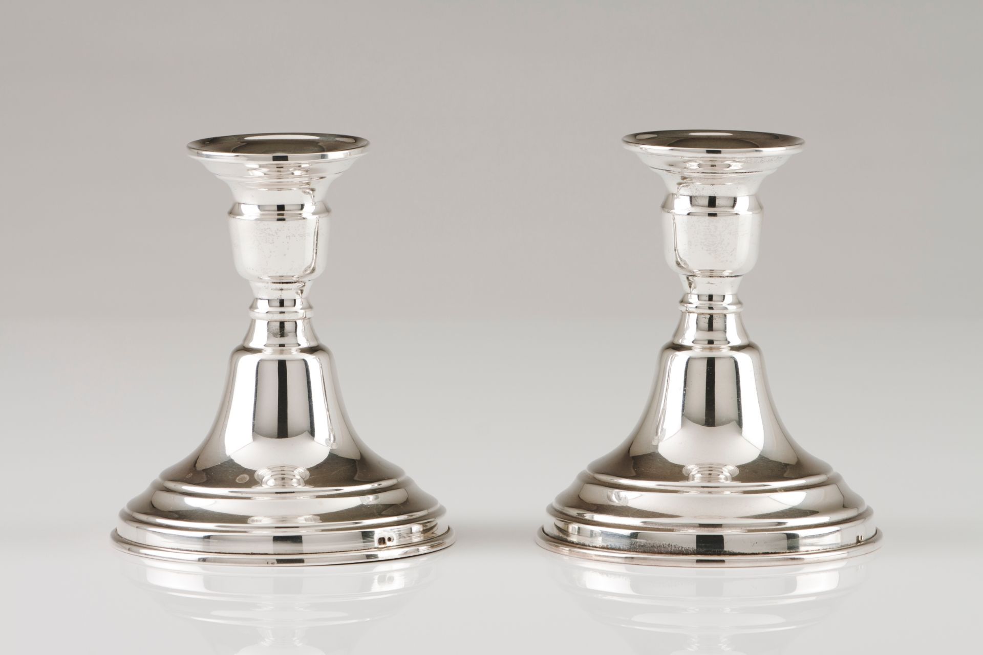 A pair of small candle standsPortuguese silver Plain turned loaded body Eagle hallmark 925/1000