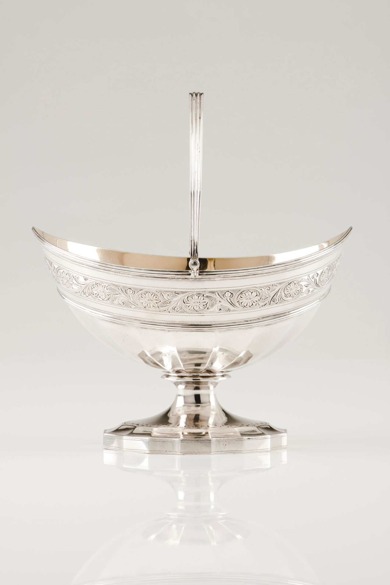 A sweetmeats dish with handleEnglish silver, 18th century Boat shaped of part faceted and engrav