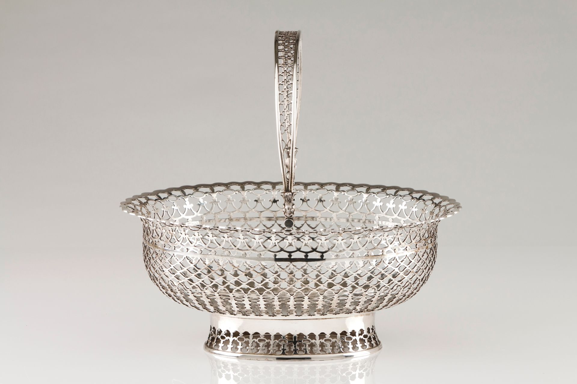 A bread basketPortuguese silver, 19th century Plain centre, geometric motifs pierced oval shaped