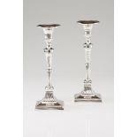 A pair of neoclassical candlestandsPortuguese silver, 19th century Fluted shaft, cup and foot on